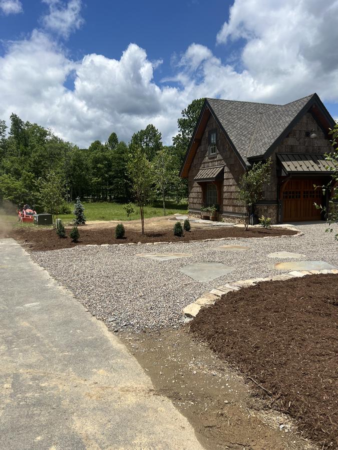 Lakefront home driveway with new mulch beds and gravel edging