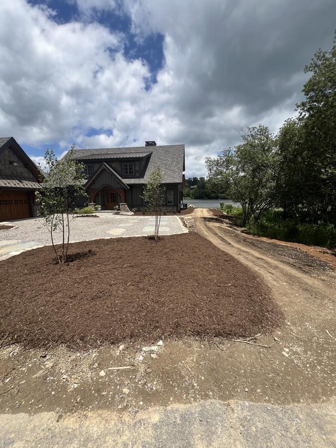 Lakefront property new mulch beds and tree planting