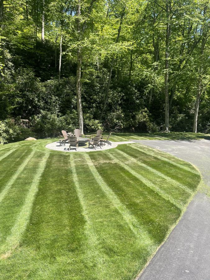 Precision lawn care with outdoor fire pit — Foothills Outdoor Services